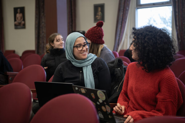 two students chatting in lecture hall