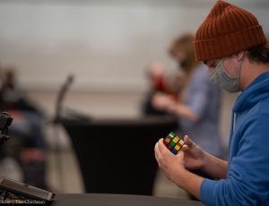 Photo of Joshua Boston, student competitor, solving the Rubik's Cube