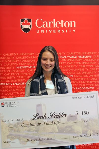 Leah Piehler, honourable mention for the 2016 Undergraduate Co-op Student of the Year Award, posing with her novelty cheque at the Co-op Awards reception. 