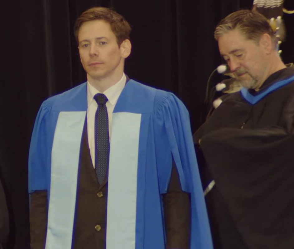 Phd graduate in graduation gown