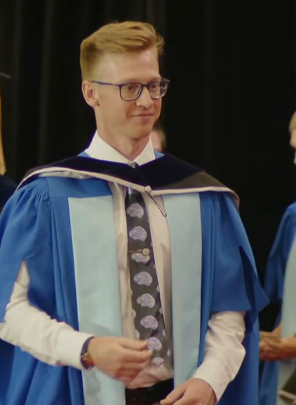 Phd graduate in graduation gown
