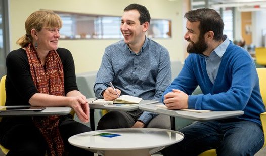 (Left to right) Carleton professor Patricia Ballamingie, Jason Garlough of the Ottawa Eco-Talent Network, and doctoral research assistant Michael Lait sit around a table discussing community engagement in anticipation of Carleton’s fourth annual Community Engagement Event on Feb. 24, 2016.