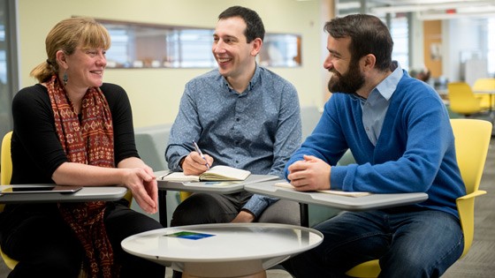 (Left to right) Carleton professor Patricia Ballamingie, Jason Garlough of the Ottawa Eco-Talent Network, and doctoral research assistant Michael Lait sit around a table discussing community engagement in anticipation of Carleton’s fourth annual Community Engagement Event on Feb. 24, 2016.