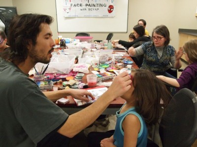 A little girl gets her face painted as part of Station 20 West's community activities.
