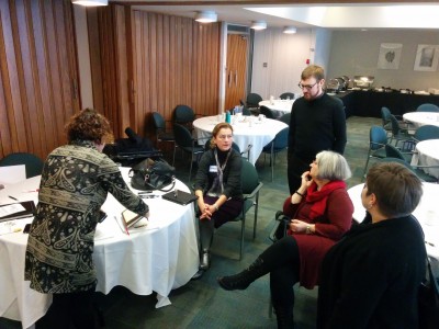University of Victoria researchers sit around a table discussing the implications of the meeting that just finished.