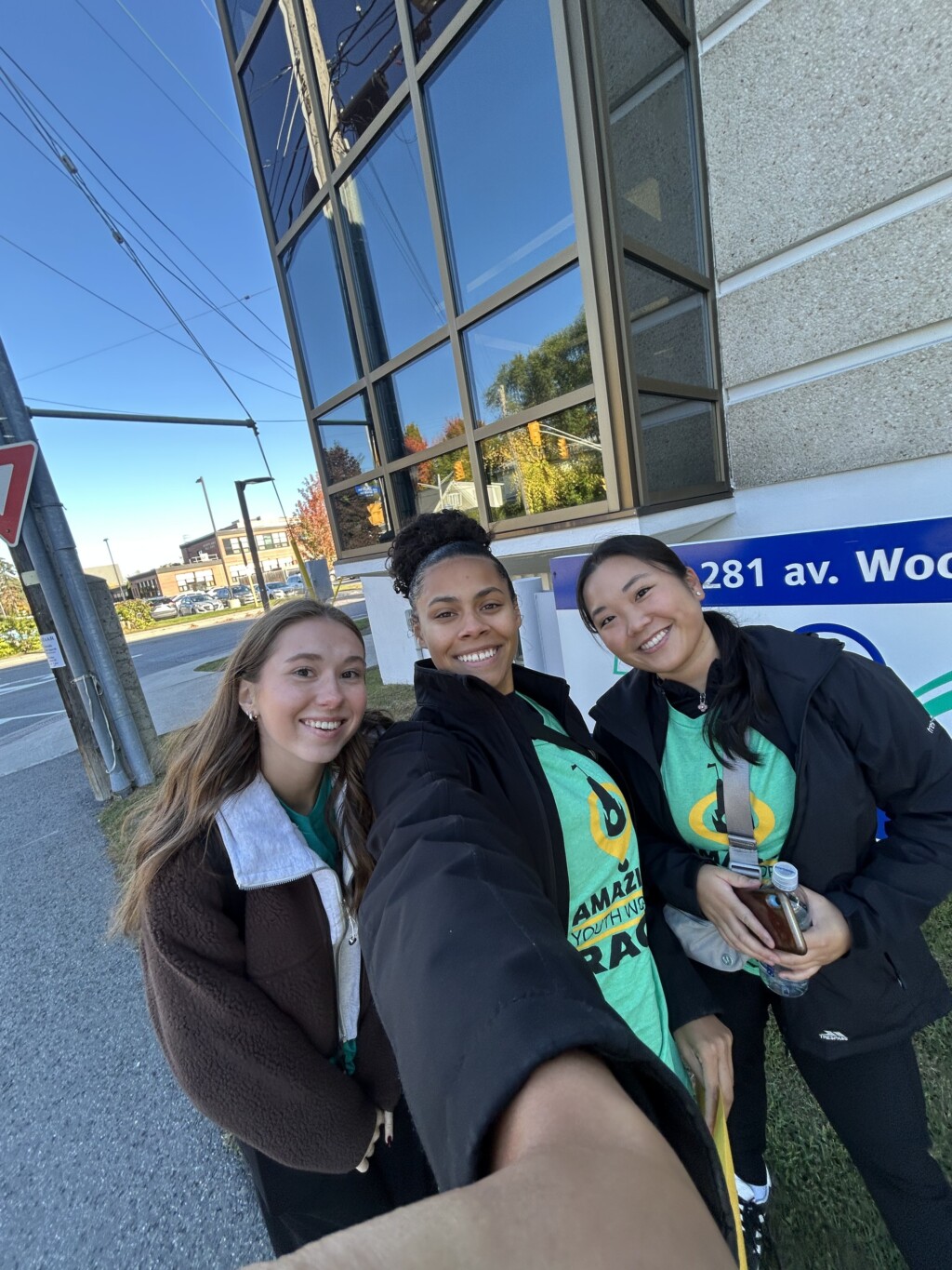 three students in from of a building