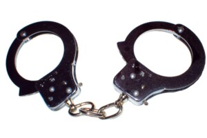 Silver handcuffs on white background