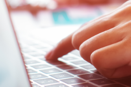Close up of hand on laptop keyboard