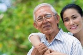 Vietnamese woman embracing older Vietnamese man