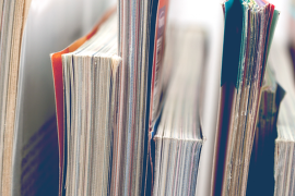 Different-sized books stacked vertically