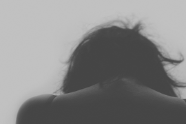 Back of woman's neck with her head looking down