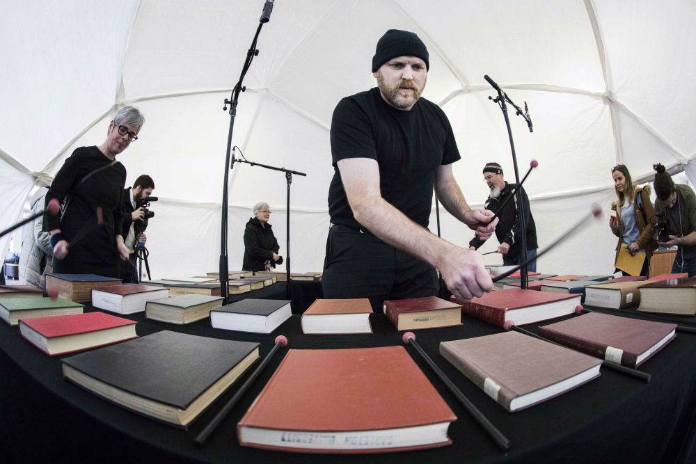 Jesse Stewart plays the bibliophone in the geodesic dome surrounded by students