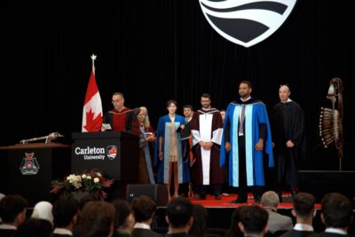 Xinrui Zhang waiting to be called onto the stage for hooding at Convocation 2025