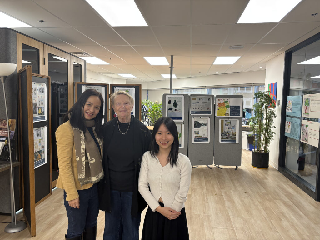 Three people stand together in the exhibit.