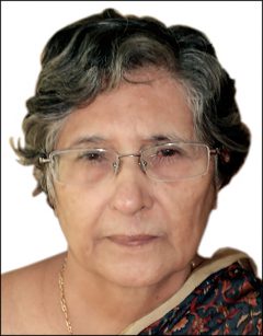 This is a portrait of a woman with short curly hair. She is wearing glasses.