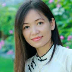 This is a portrait of woman with long black hair and wearing white ao dai- the traditional costume of Vietnam.