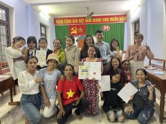 This is a group photo. Some girls and women are holding their zines.