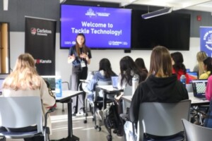 A Virtual Ventures instructor talks to a group of girls