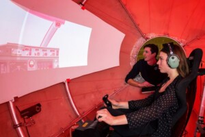 Carleton students driving airplane simulator