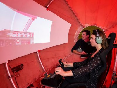 Carleton students driving airplane simulator