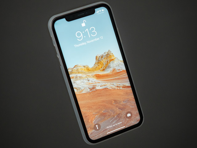 An iPhone with its lock screen and time displayed.