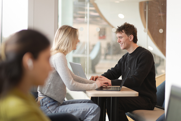 Two people having a conversation at a table.