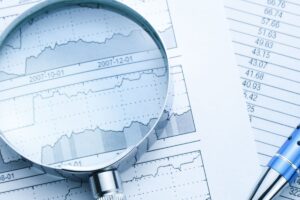 magnifying glass on paper charts