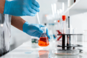 hands holding laboratory beaker