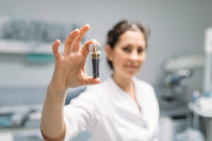 woman holding small mechanical device