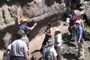 multiple students at an outdoor dig site