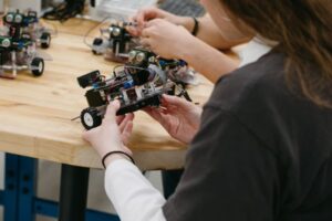 student holding robotic device with wheels