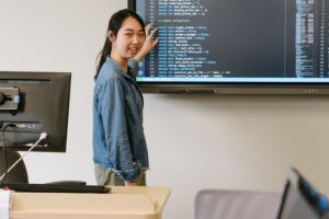 Three students in computer server room talking