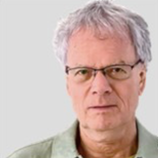 Donald is a white man with grey hair and glasses, wearing a light green shirt