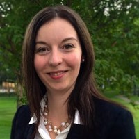 Briana portrait outside with green trees