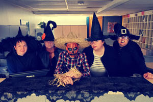 5 administrative staff posed at front counter in cu_event_costumes