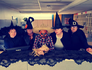 5 administrative staff posed at front counter in cu_event_costumes