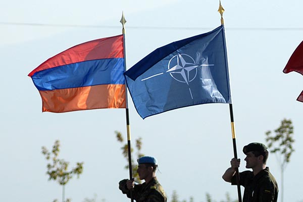 Photo of the NATO flag and the Armenian flag