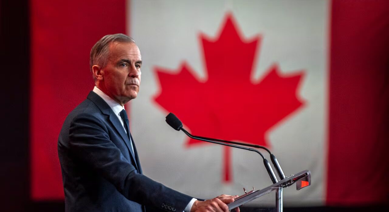 Pm Mark Carney infront of a Canadian flag