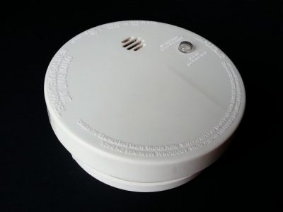 Smoke alarm sitting on black background.