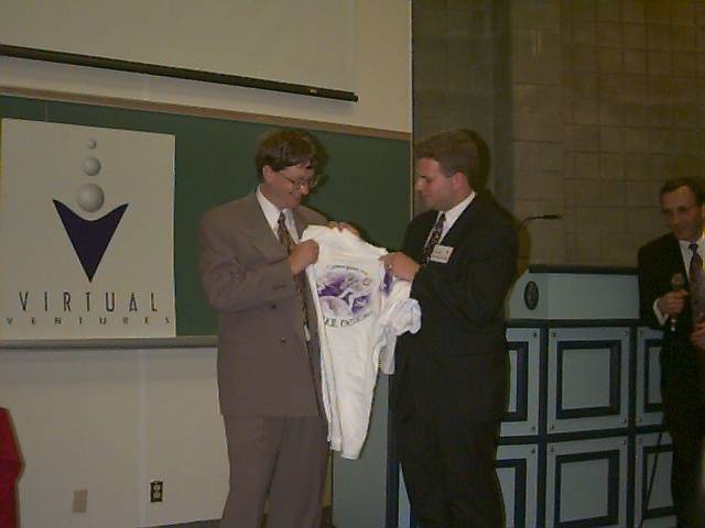 Virtual Ventures presenting a t-shirt to Bill Gates in 1995.