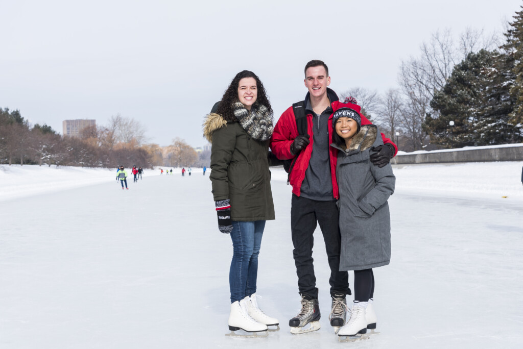 Students on the canal, wearing skates, smiling