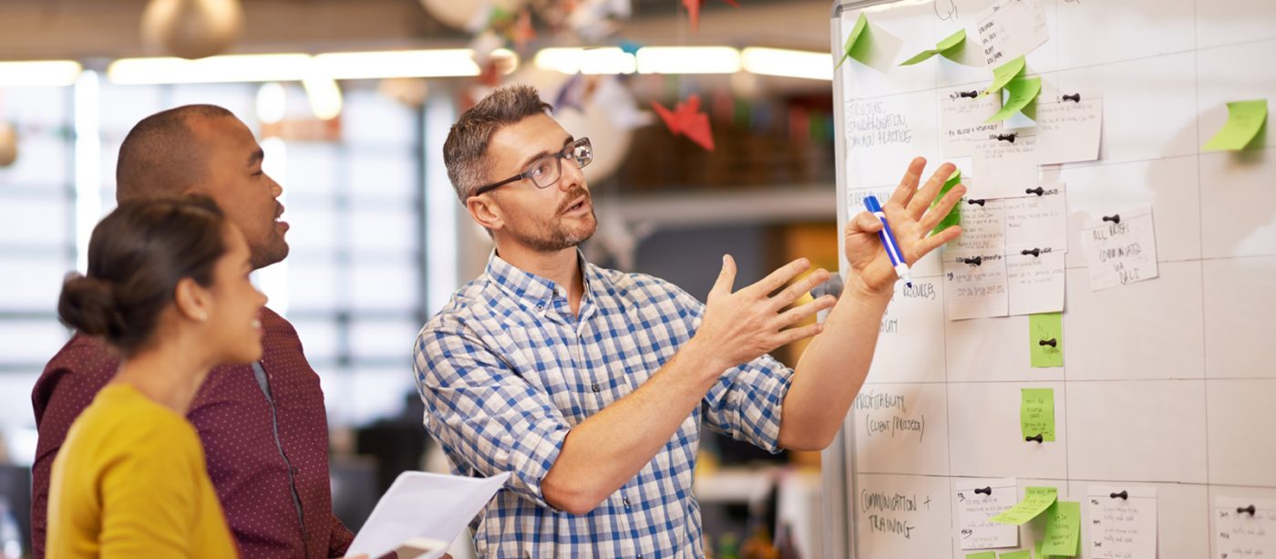 professor with students at whiteboard