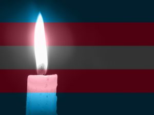 A candle against a trans flag background
