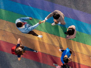 people walking across a rainbow crosswalk, when clicked brings you to Carleton's Pride Festival page
