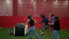 Students playing archery tag.