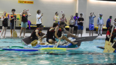Students in their raft in the pool.