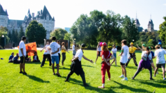 Students playing on the lawn by Parliament Hill.