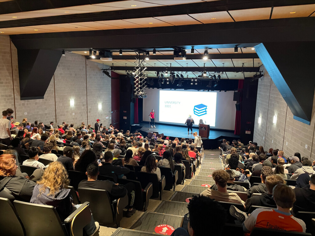 Students leading a presentation to a full classroom.