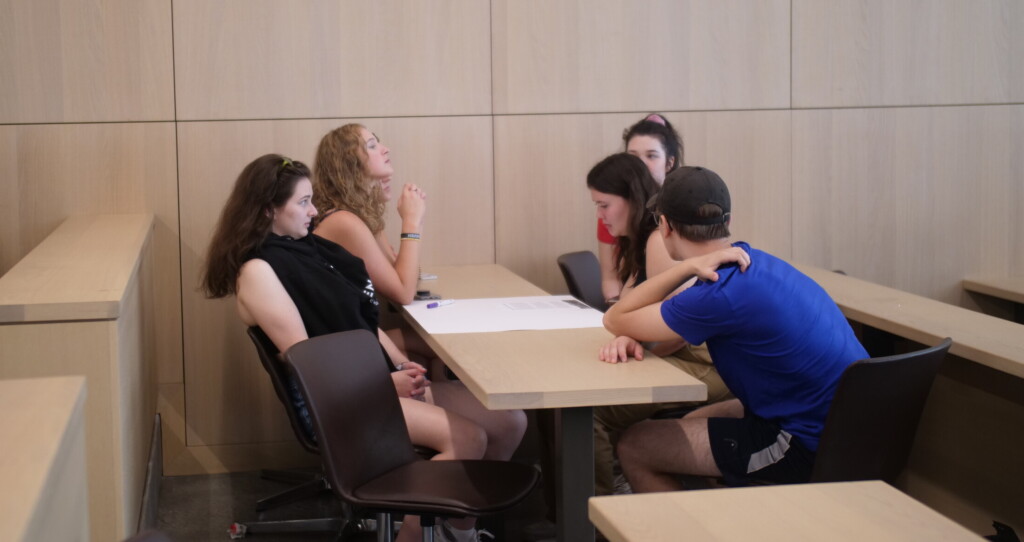 Students working on a case together in classroom.