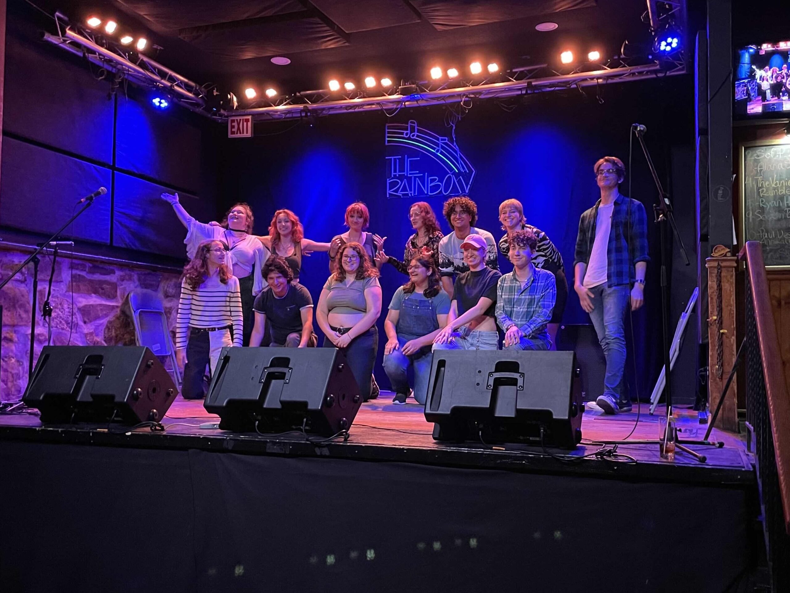 Student on stage after performing an improv show.